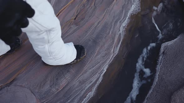 the Astronaut Walks Slowly and Carefully Along the Stream alt