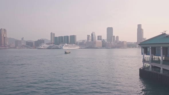 Hong Kong star ferry heading towards Kowloon. Aerial drone view alt