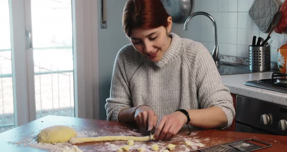 Young Girl is Making Homemade Potato Italian Gnocchi in the House alt