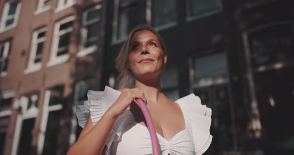 Woman smiles proudly in the sun alt