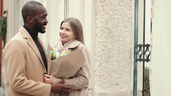 Affectionate Young Woman Hugging Her Boyfriend in the City alt