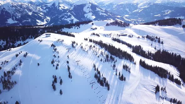 Panoramic top view from drone on cable way in ski resort. Ski lift elevator transporting skiers and alt