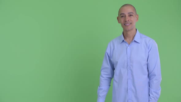 Happy Bald Multi Ethnic Businessman Snapping Fingers and Giving Thumbs Up alt