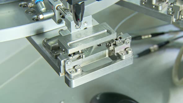 Advanced industrial production line for small parts, robotic arms working alt