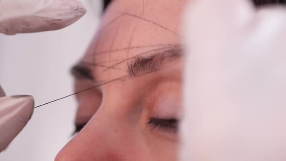 Closeup of Building a Universal Classic Sketch of Symmetrical Eyebrows Before the Procedure of alt