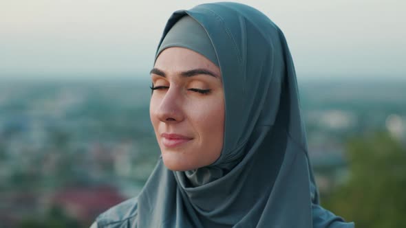 Close Up Portrait of Beautiful Woman in Hijab on Top of the Hill in the Evening