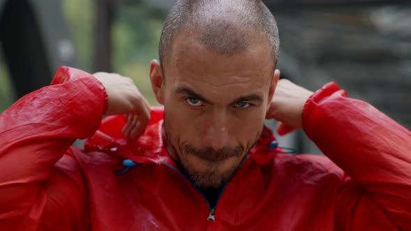 Portrait of an Unshaven Man on the Background of a Blurred Railway Bridge alt