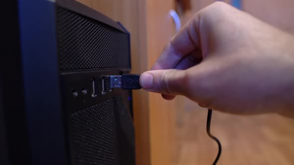An Office Worker Tries To Insert The Cord Into The Usb Connector Of The Computer