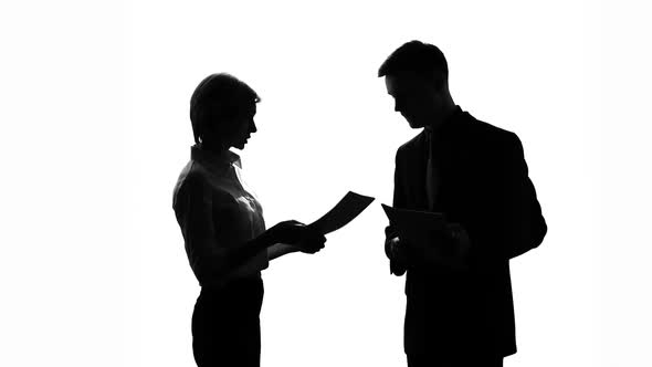 Male and Female Colleague Silhouettes Arguing Over Business Documents at Office alt