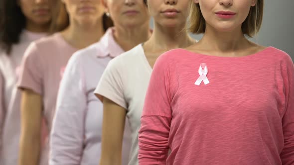 Group of Ladies With Pink Ribbons Recommending Timely Diagnosis of Breast Cancer alt