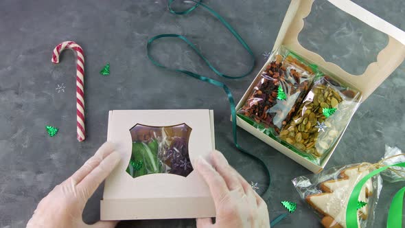 Girl wraps Christmas gift box natural dried fruits nuts individually wrapped set Healthy food snack alt