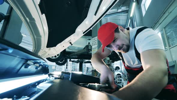Auto Mechanic Uses a Wrench to Fix a Car alt