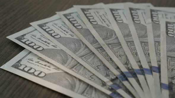 Fall of USD currency on a table 4K 2160p 30fsp UltraHD footage - Dropping American dollar banknotes  alt