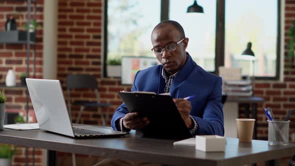 Project Manager Analyzing Statistics Plan with Application Report alt