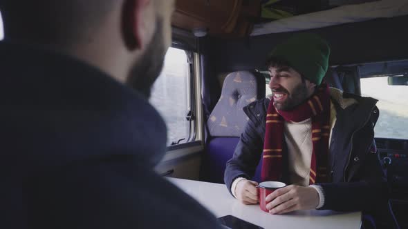 Man in camper van looking at hills alt