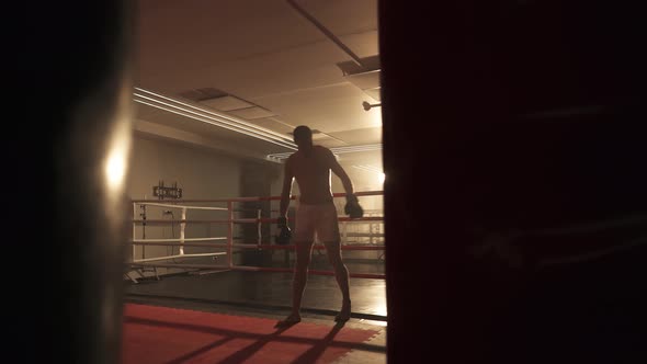 Kickboxing, the Athletic Man Fighter Stands Near the Boxing Ring After Training, Training Day in the alt