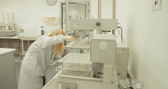 Scientist working in a pharmaceutical laboratory conducting experiments alt