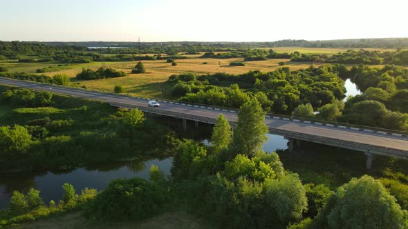 A Bridge That Cars Drive Across A Wide River