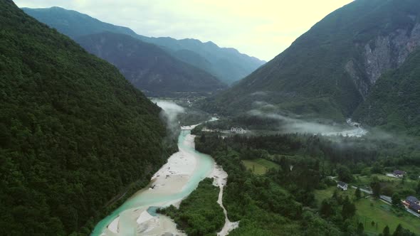 Aerial view of Soca river valley with a lot of nature and hills in Slovenia.