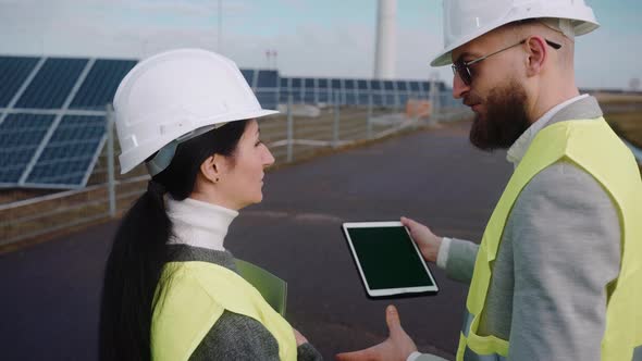 Close Up of Ecological Engineers Use Digital Tablet and Talk at the Powerhouse