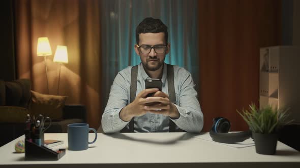 Man Writing the Text for Work Using the Mobile Phone alt