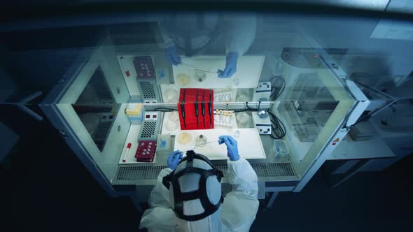 Coronavirus COVID-19 Concept. Laboratory Box with a Specialist Holding Biochemical Tests alt