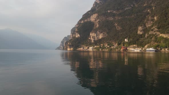 Picturesque Lake Garda, Italy. Aerial View of Steep Coastline, Cruise Ship, Bird Flying Above Calm W alt