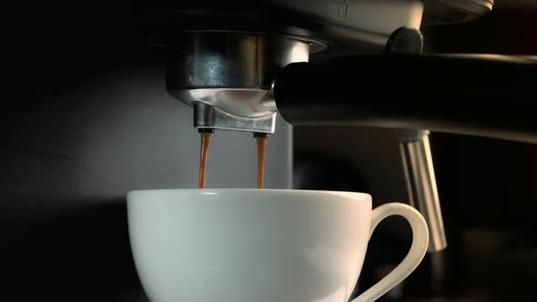 Pouring Coffee Stream From Machine in Cup alt