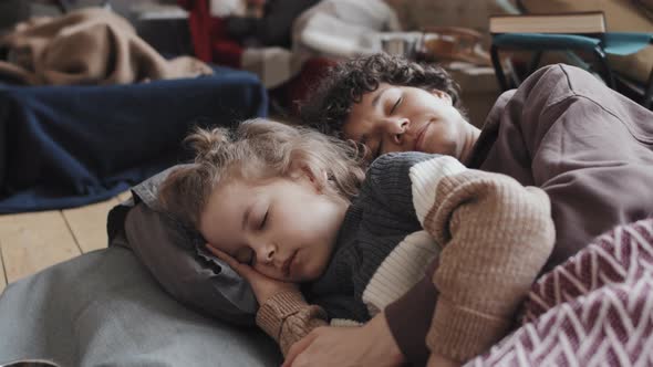 Mother and Kid Sleeping in Flee Camp alt