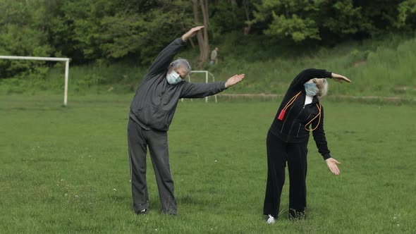 Active Senior Old Couple. Man and Woman Do Stretching Physical Exercises alt