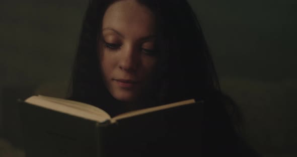Woman Reading A Book. Close-up.