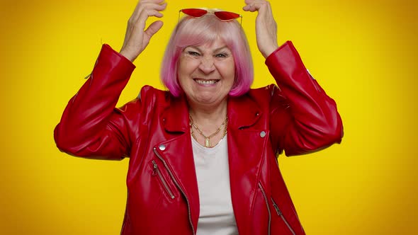 Senior Old Grandma Woman Making Playful Silly Face Expressions Grimacing Fooling Dancing alt