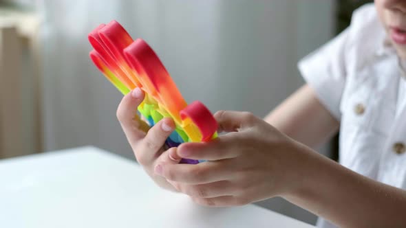 Child Play with Pop It Sensory Toy alt