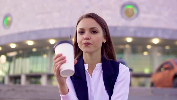 Beautiful Girl, Drinking Coffee, on the Street in the Evening City, Looking alt
