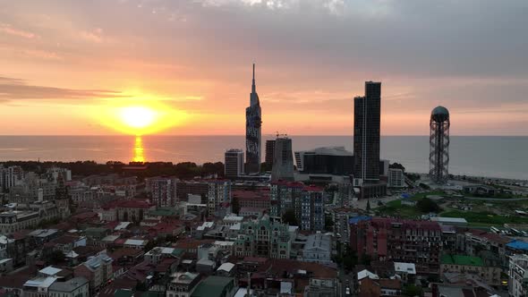 Aerial shot at sunset of modern buildings in downtown of Batumi. Georgia 2022 summer alt