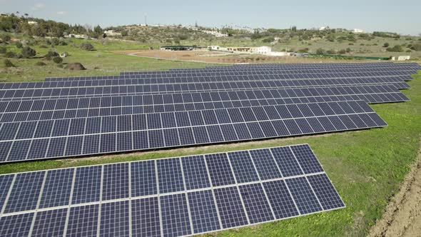 Aerial view rows of Solar panels on green field, Electrical station. Parallax motion