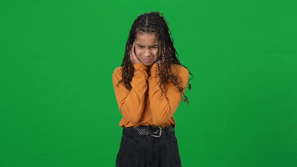 Portrait of Teen African American Girl Suffering From Loud Noise Looking at Camera Shaking Head No alt