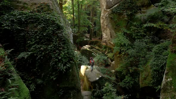 Woman Hiker with Backpack at Dovbush Rocks Canyon alt