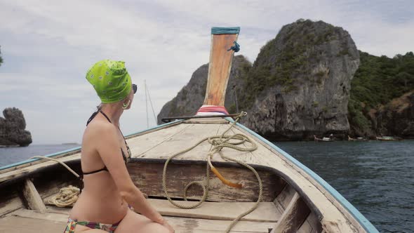 Happy Woman Traveler in Bikini Relaxing on Boat
