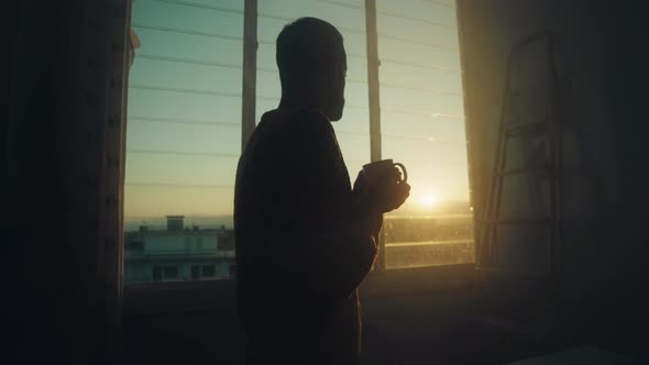 boy at the window with cup of milk alt