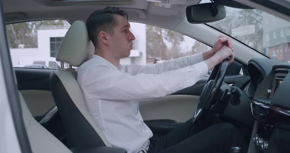 Sad Depressed Man Sitting in a Car Suffering From Despair alt