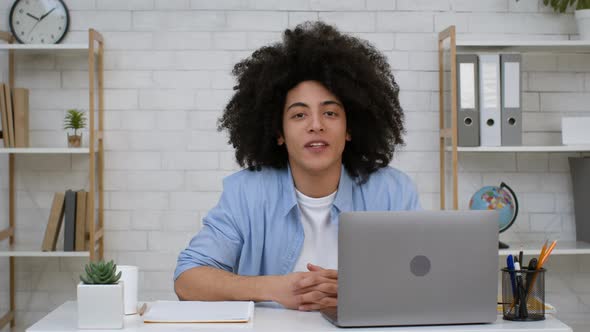 Young Black Teacher Man At Laptop Talking Having Webinar Indoors alt