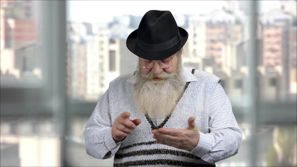 Senior Man Calculating on Invisible Device for Copyspace alt