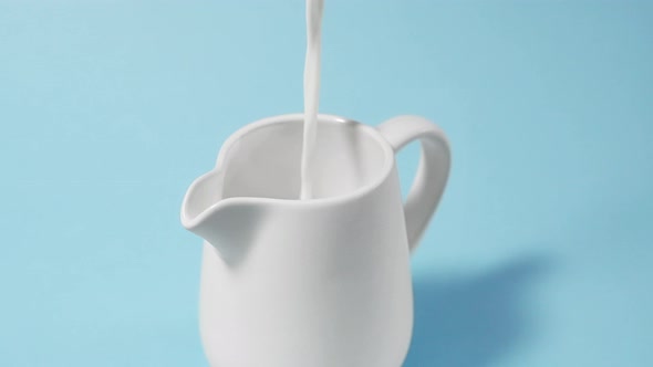 Milk is Poured Into a Milk Jug