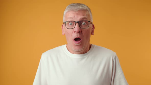 Handsome Senior Man Wearing Glasses Afraid and Shocked with Surprise Expression