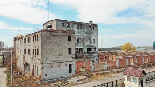Abandoned building. Aerial view of an old factory ruin and broken windows. alt