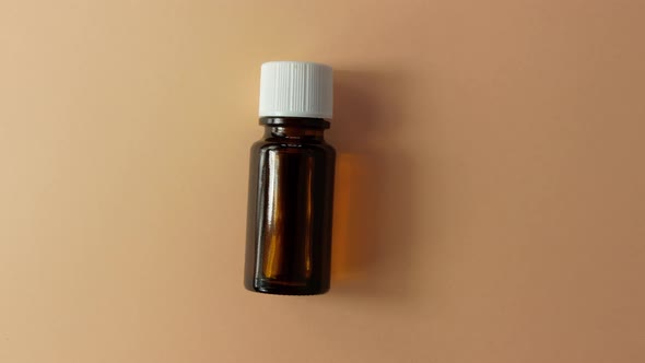 Herbal essential oil glass bottle mockup beige pastel background Alternative medicine aromatherapy