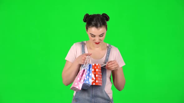 Girl Takes Out Small Box From the Packages and Is Very Happy on Green Screen alt