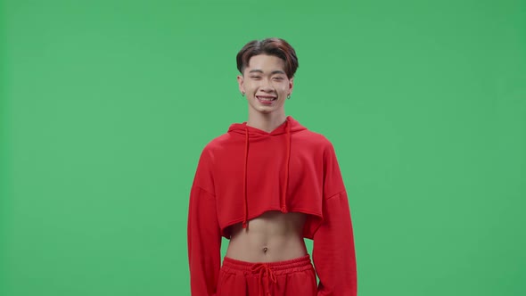 Asian Transgender Male Positively Shaking Her Head At The Camera In The Green Screen Studio alt