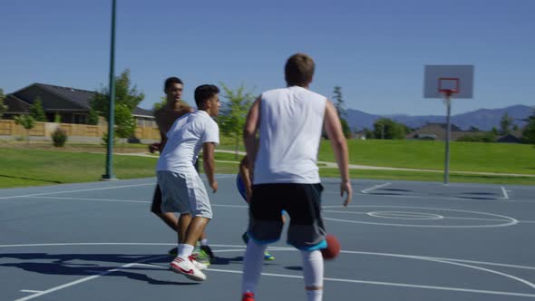 Slow motion shot of friends playing basketball at park